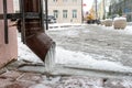 The drainpipes are covered with ice and snow. After a heavy snowstorm, the city is covered with snow and ice. There are many