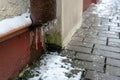 The drainpipes are covered with ice and snow. After a heavy snowstorm, the city is covered with snow and ice. There are many