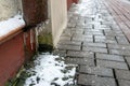 The drainpipes are covered with ice and snow. After a heavy snowstorm, the city is covered with snow and ice. There are many