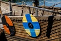 Drakkar, Viking boat moored near the grassy shore. Round shields on the housing