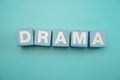 Drama word created with cubes alphabet letters on blue background Royalty Free Stock Photo
