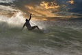 Dramaic surfer sihouetted at sunaset on a breaking wave. Royalty Free Stock Photo