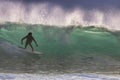 Dramaic surfer sihouetted at sunaset on a breaking wave. Royalty Free Stock Photo