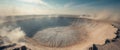 Dramatic Aerial View of a Deep Crater Possibly Meteor Impact Rocky Surface Dust Clouds Royalty Free Stock Photo