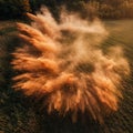 A dramatic aerial view of a dust explosion in a field. The orange-brown dust rises and Royalty Free Stock Photo