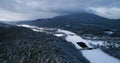 Flying over the Cornish-Windsor Covered Bridge and Connecticut River in New England after a snowstorm