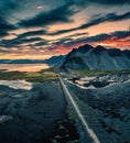 Vestrahorn mountain and road among black sand beach in the sunset at Stokksnes, Iceland Royalty Free Stock Photo