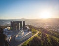 Dramatic aerial view udown to the tops of giant columns of Chronicles of Georgia. Sightseeing and tourist sites in Sakartvelo.