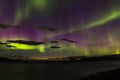 Dramatic aurora borealis, polar lights, over mountains in the North of Europe - Lofoten islands, Norway Royalty Free Stock Photo