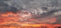 Dramatic beautiful clouds during sunset. Cumulus clouds illuminated in orange and pink. Dark and gray tones. Banner. Delicate Royalty Free Stock Photo