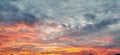 Dramatic beautiful clouds during sunset. Cumulus clouds illuminated in orange and pink. Dark and gray tones. Banner Royalty Free Stock Photo