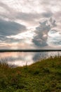 Dramatic beautiful pink blue orange sunset at river with reflection and clouds on natural background Royalty Free Stock Photo