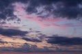 Dramatic beautiful sunrise, sunset pink violet blue sky with dark storm clouds background texture Royalty Free Stock Photo