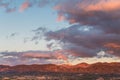 Beautiful sunset casts purple and orange colors on clouds and mountains over a neighborhood in Tesuque, near Santa Fe, New Mexico Royalty Free Stock Photo