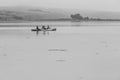 Dramatic black snd white image of tourist kayaking on the California coast enjoying the calm waters of Bodega Bay, California. Royalty Free Stock Photo