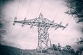 Electricity transmission power lines and post against blue sky at mountain Royalty Free Stock Photo