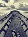 Dramatic black and white image of feet in boat, Inle lake, Myanmar Royalty Free Stock Photo