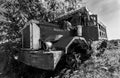 Dramatic black and white image of a old abandoned rusty truck in an overgrown field in the caribbean.