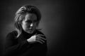 Dramatic black and white portrait of a beautiful woman on a dark background