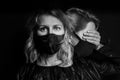 Dramatic black and white portrait of young blonde woman in face mask Royalty Free Stock Photo