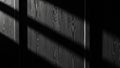Dramatic black and white of a wooden wall with strong diagonal light and shadow patterns Royalty Free Stock Photo