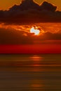 Dramatic bloody sunrise on dark sky over sea Royalty Free Stock Photo