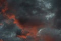 Dramatic blue-black sky with orange clouds and gaps during sunset Royalty Free Stock Photo