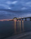 Dramatic blue hour stormy scene over a long steel tied arch bridge