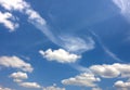 Dramatic blue sky with puffy white clouds in bright clear sunny