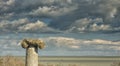 Dramatic blue sky with white clouds over the ruins of an ancient greek column at Histria, on the shores of Black Sea. Histria is Royalty Free Stock Photo