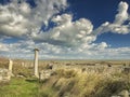 Dramatic blue sky with white clouds over the ruins of an ancient greek column at Histria, on the shores of Black Sea. Histria is Royalty Free Stock Photo