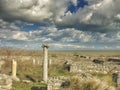 Dramatic blue sky with white clouds over the ruins of an ancient greek column at Histria, on the shores of Black Sea. Histria is Royalty Free Stock Photo