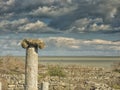 Dramatic blue sky with white clouds over the ruins of an ancient greek column at Histria, on the shores of Black Sea. Histria is Royalty Free Stock Photo