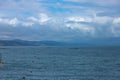 Dramatic blurred mountain landscape on the Black Sea beach, landscape with clouds and sky, reflected in the water