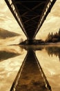 Dramatic Bridge Over Calm Water Under a Golden Sky Reflection Royalty Free Stock Photo