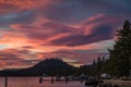 Dramatic pink and blue sunset with a round hill, boat and doc from Lakeside Beach at Lake Tahoe