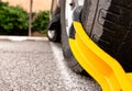 Dramatic car tire with yellow boot Royalty Free Stock Photo