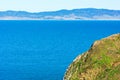 Dramatic cliff covered with green grass on a sunny day at Point Reyes National Seashore in California