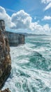 Dramatic cliffside with rough seas and cloudy sky Royalty Free Stock Photo