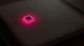 Glowing magenta microchip rests on dark ancient book Royalty Free Stock Photo