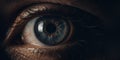 Close up macro photography of a striking blue human eye with intense gaze and intricate details Royalty Free Stock Photo