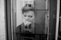 Dramatic close up portrait of young beautiful woman thinking and feeling sad suffering depression at home window looking depresse Royalty Free Stock Photo