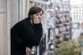 Young beautiful woman thinking and feeling sad suffering depression at urban city background home balcony