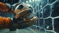 A dramatic closeup of the soccer ball just inches away from the goalkeepers gloves Royalty Free Stock Photo