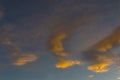 Dramatic cloud sky with dark rain clouds and bright clouds illuminated by the low sun, glowing in the evening glow before and Royalty Free Stock Photo