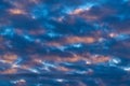 Dramatic clouds in blue sky, illuminated by rays of sun at colorful sunset to change weather. Abstract meteorology Royalty Free Stock Photo