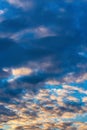 Dramatic clouds in blue sky, illuminated by rays of sun at colorful sunset to change weather. Summer cloudscape Royalty Free Stock Photo