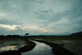 Dramatic clouds at dusk in the middle of field Royalty Free Stock Photo