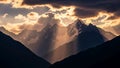Dramatic clouds over a jagged mountain range highlighting snow capped Royalty Free Stock Photo