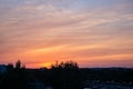 dramatic clouds on red sky over city roof tops Royalty Free Stock Photo